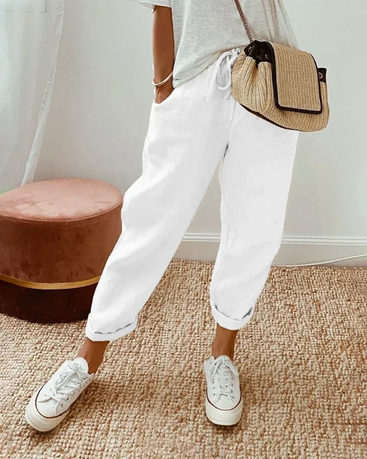 Women's breathable white linen pants featuring a relaxed fit, perfect for casual wear and warm weather styling. 3