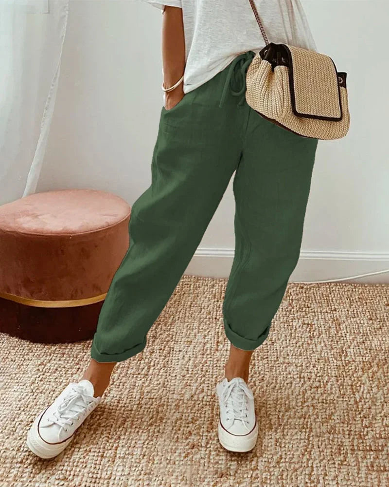 Women's breathable white linen pants featuring a relaxed fit, perfect for casual wear and warm weather styling. 4