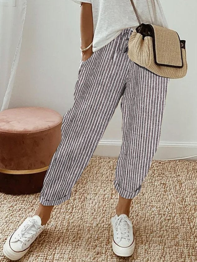 Women's breathable white linen pants featuring a relaxed fit, perfect for casual wear and warm weather styling. 5