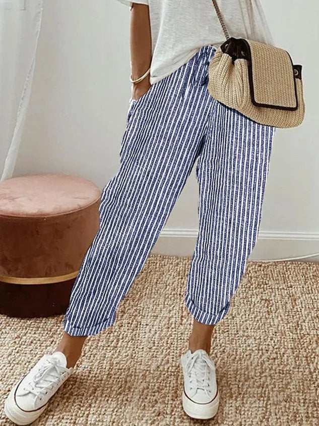 Women's breathable white linen pants featuring a relaxed fit, perfect for casual wear and warm weather styling. 7