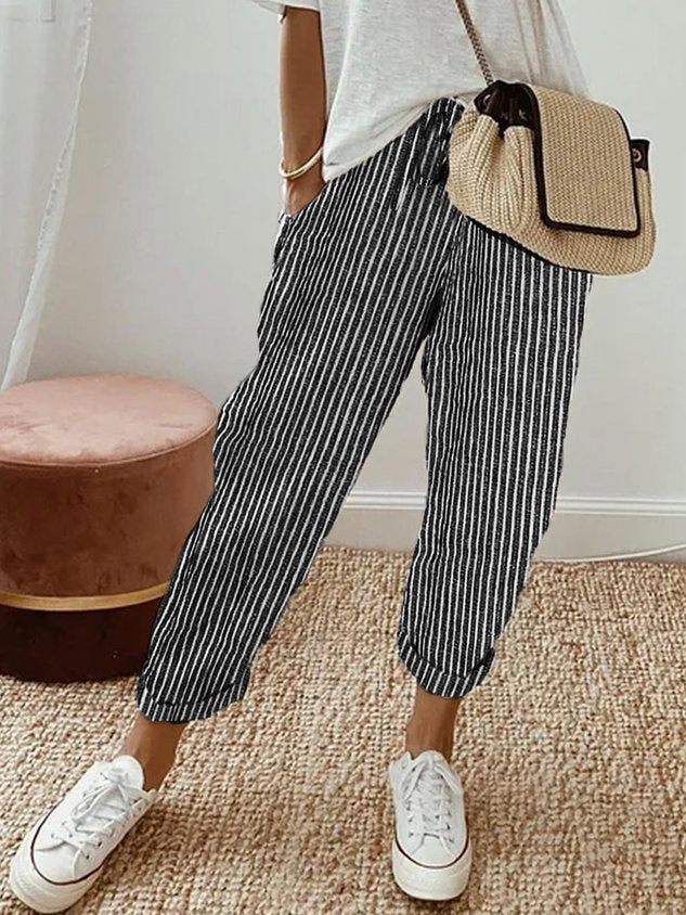 Women's breathable white linen pants featuring a relaxed fit, perfect for casual wear and warm weather styling. 8