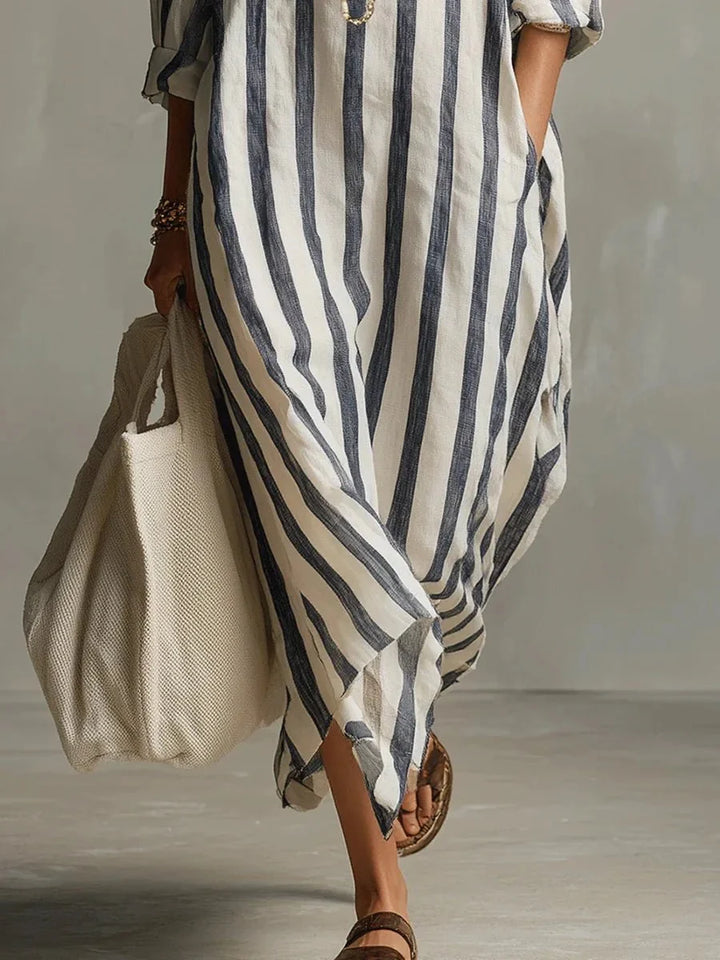 Women's striped linen maxi dress featuring adjustable roll-up sleeves, ankle-length design, and deep pockets for added convenience and style. 3