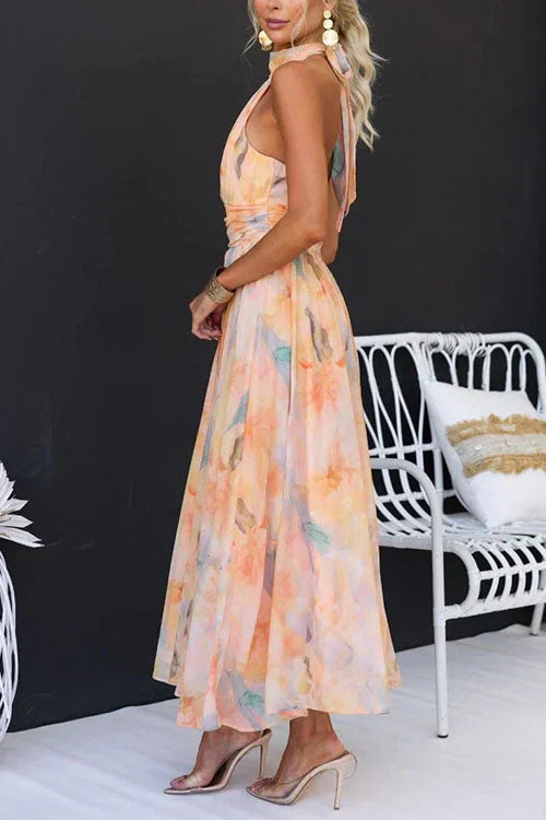 Elegant women's maxi dress featuring a stylish halter neckline and a beautiful floral pattern, perfect for summer occasions. 4