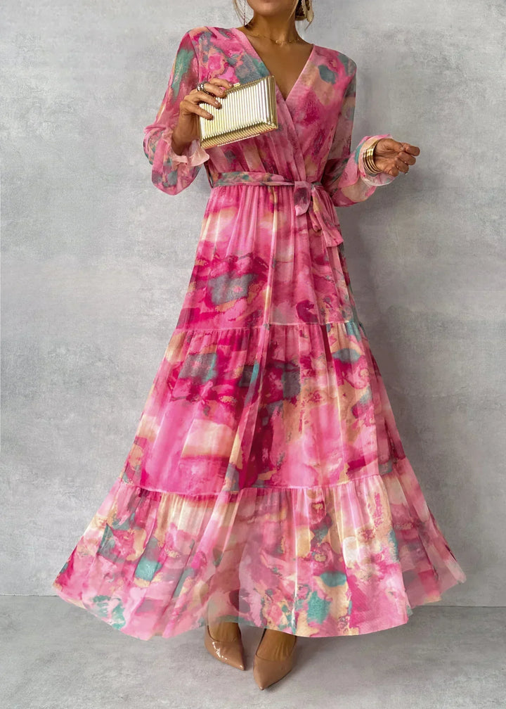 Women's maxi dress featuring a pleated design and floral pattern, elegantly belted, perfect for formal occasions and special events. 1