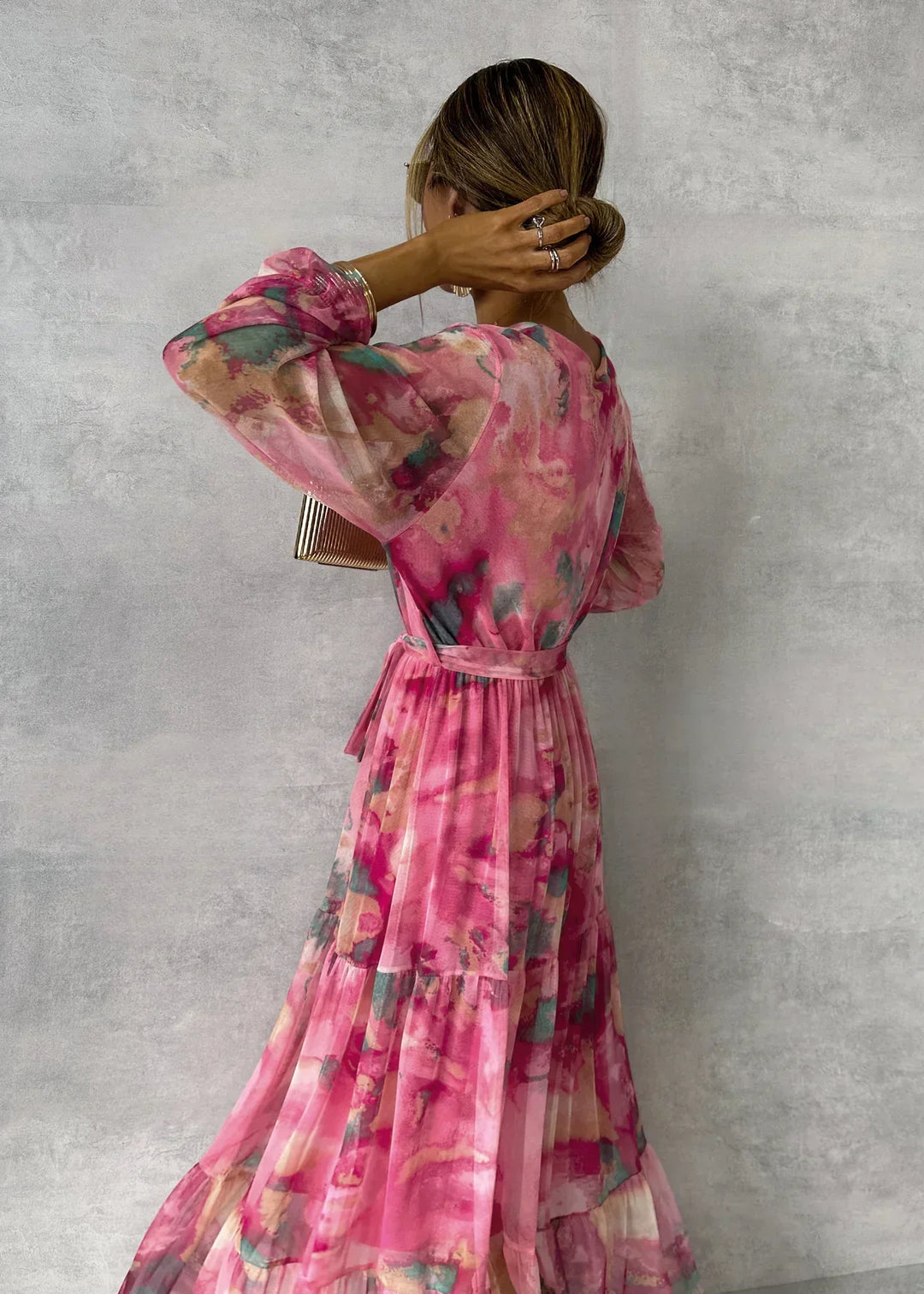 Women's maxi dress featuring a pleated design and floral pattern, elegantly belted, perfect for formal occasions and special events. 2