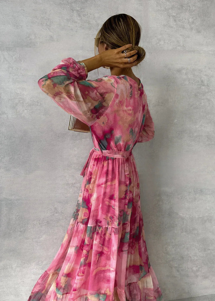 Women's maxi dress featuring a pleated design and floral pattern, elegantly belted, perfect for formal occasions and special events. 2