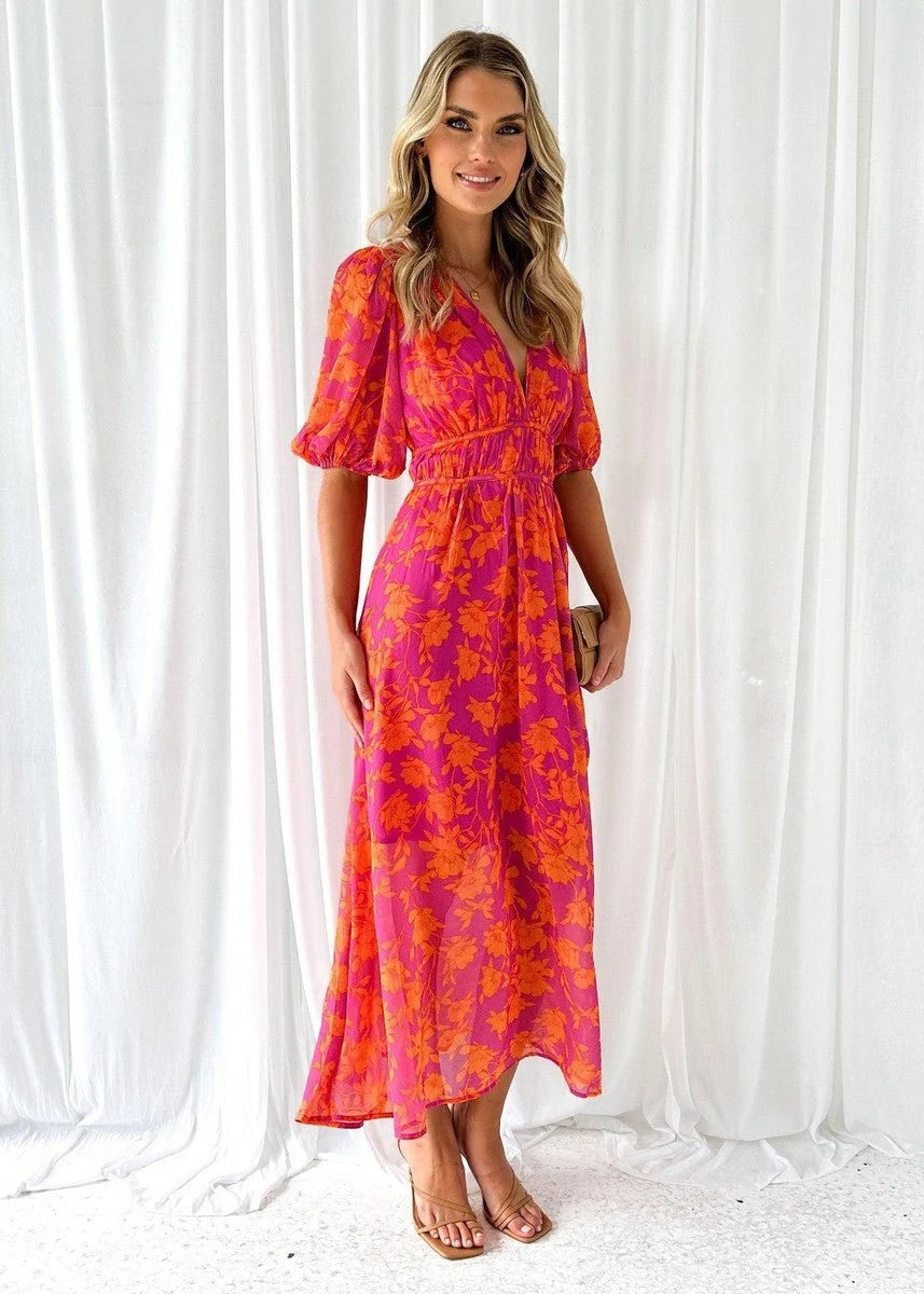 Women's midi dress featuring puff sleeves and a stylish V-neck, adorned with a vibrant floral print, perfect for autumn and winter occasions. 1