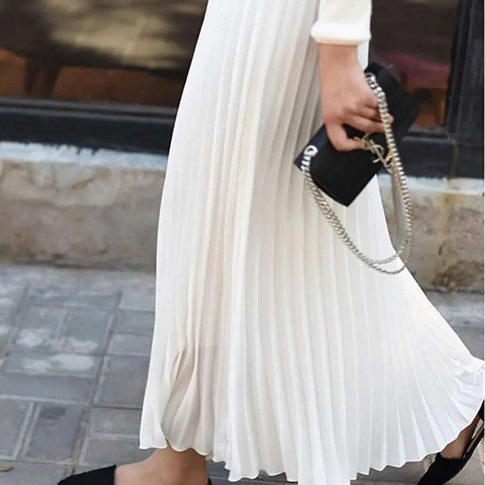 Women's black satin midi skirt featuring accordion pleats and a high waist A-line design, perfect for elegant and versatile styling. 2