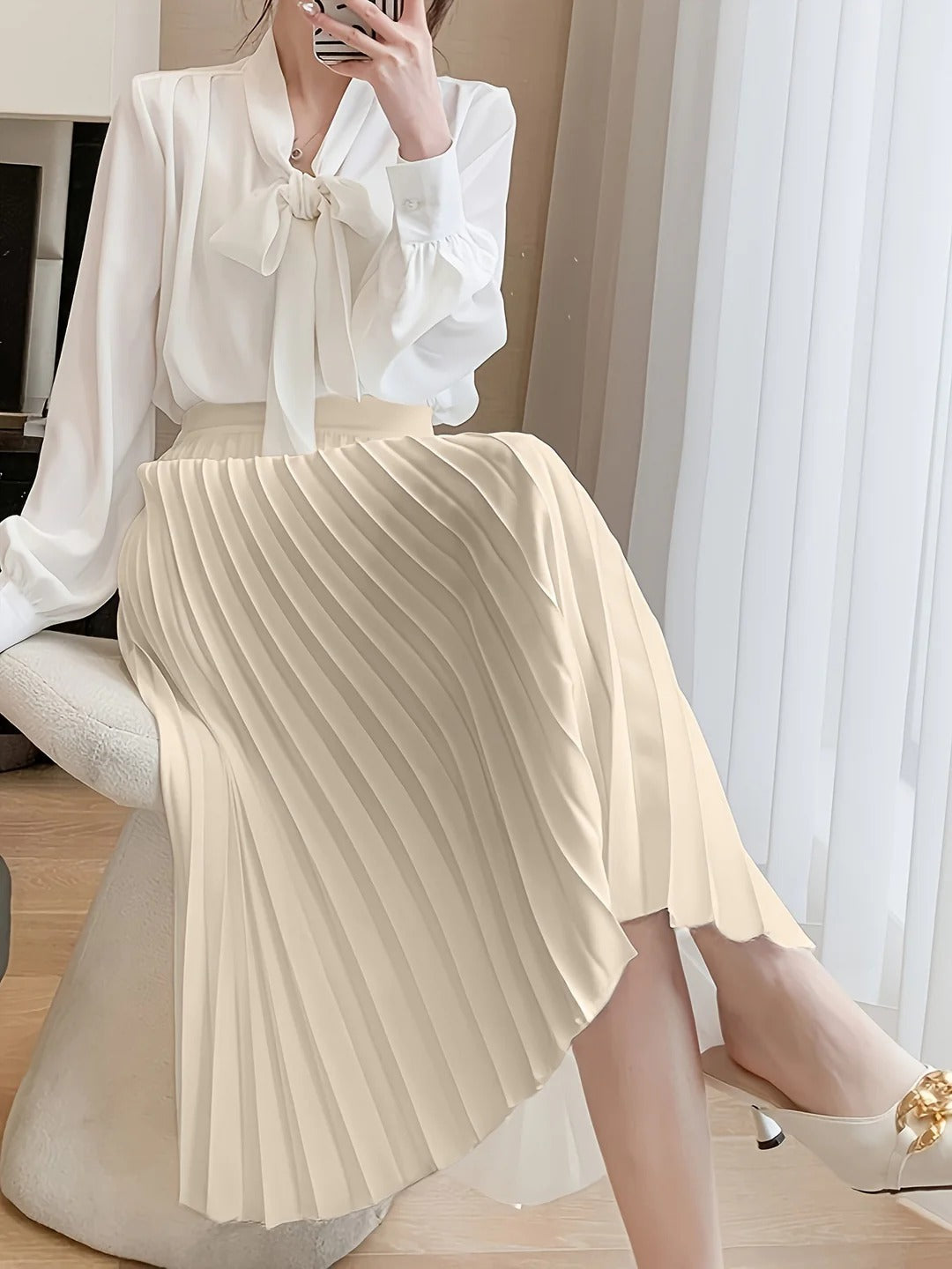 Women's black satin midi skirt featuring accordion pleats and a high waist A-line design, perfect for elegant and versatile styling. 4