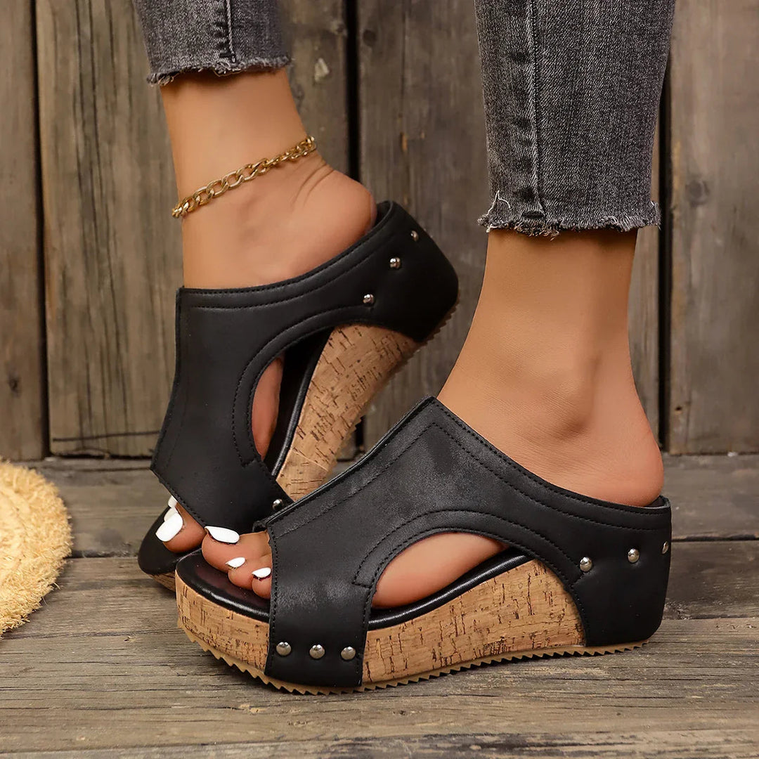 Women's platform sandals featuring studded straps and a padded insole, designed with a chic wedge for both casual and evening wear. 2