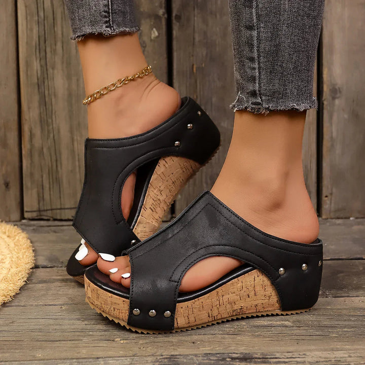 Women's platform sandals featuring studded straps and a padded insole, designed with a chic wedge for both casual and evening wear. 2