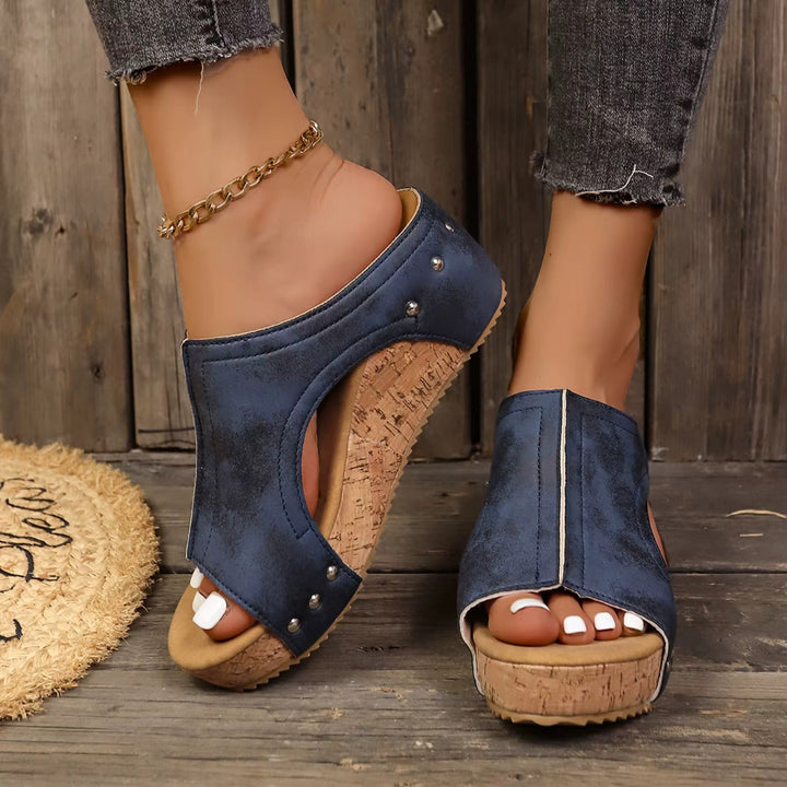 Women's platform sandals featuring studded straps and a padded insole, designed with a chic wedge for both casual and evening wear. 3