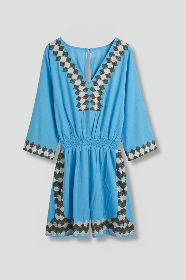 Women's sky blue playsuit featuring a smocked waist and V-neck design, lightweight fabric with elegant embroidery, perfect for summer outings. 1
