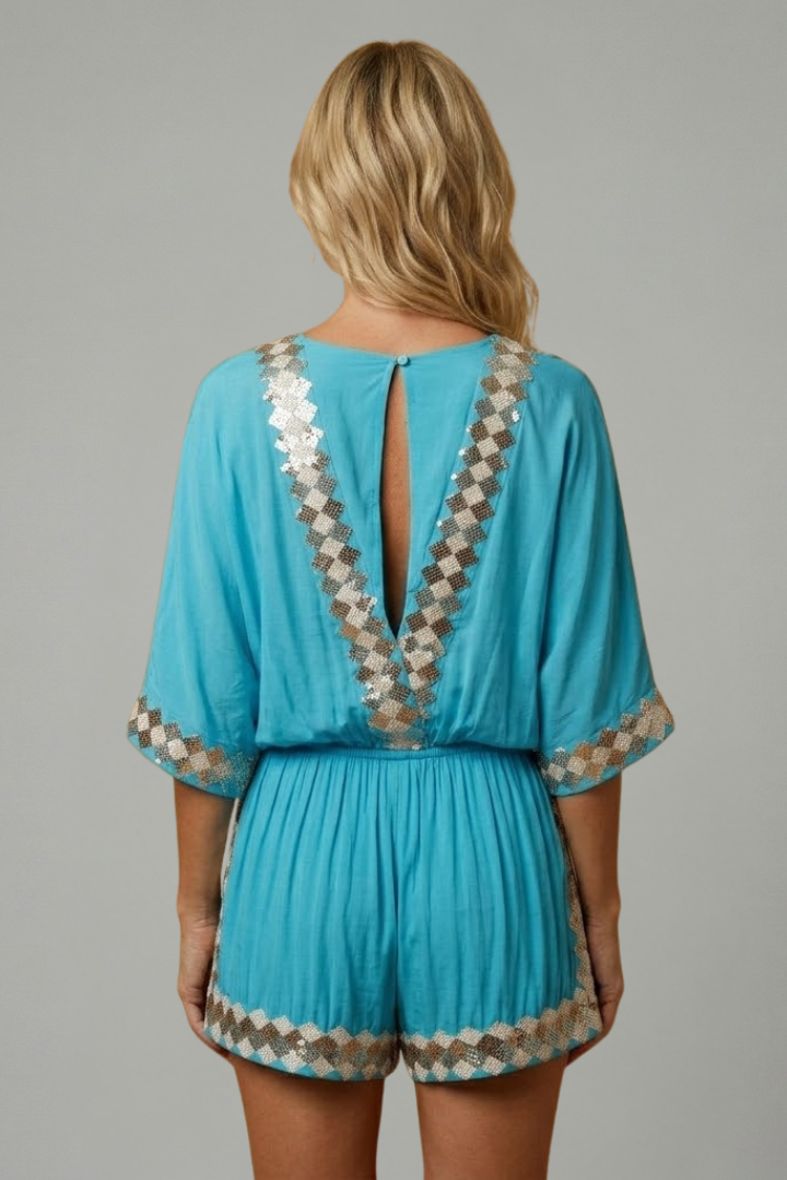 Women's sky blue playsuit featuring a smocked waist and V-neck design, lightweight fabric with elegant embroidery, perfect for summer outings. 3