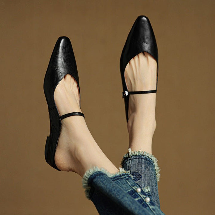 Women's black pointed-toe flats featuring a stylish buckle strap, designed for comfort as leather slip-on Mary Jane shoes, perfect for casual and formal occasions. 2