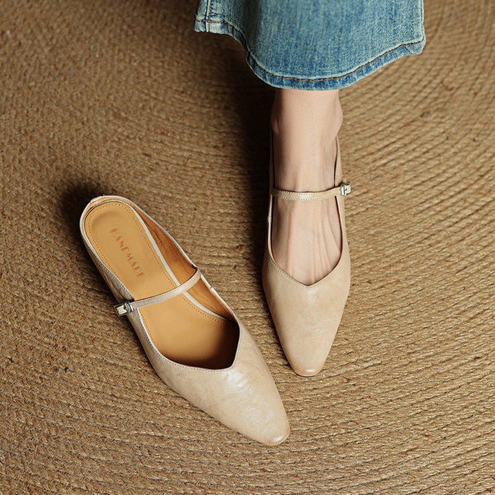 Women's black pointed-toe flats featuring a stylish buckle strap, designed for comfort as leather slip-on Mary Jane shoes, perfect for casual and formal occasions. 4