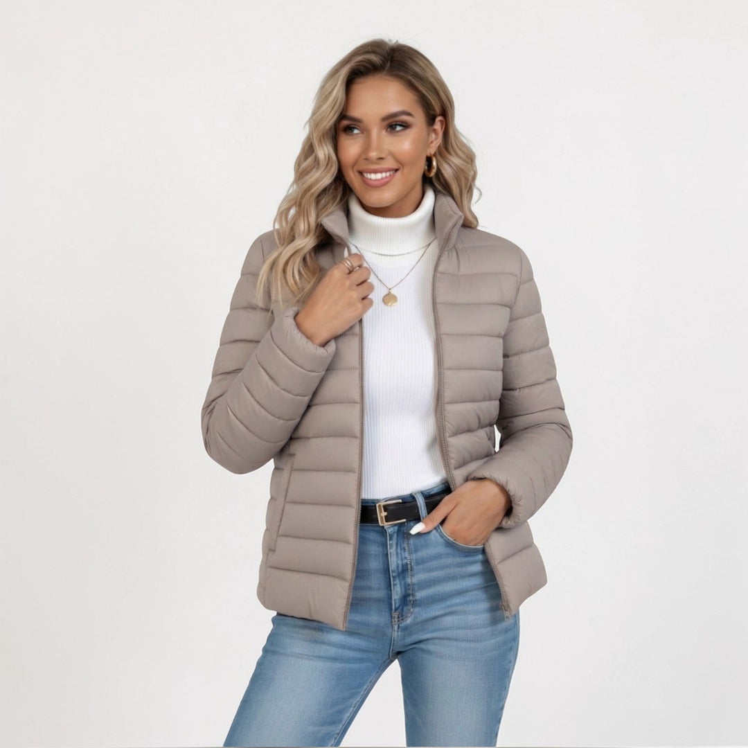 Women's quilted jacket featuring a slim fit design, lightweight construction, and casual style in a neutral tone, perfect for versatile layering. 0