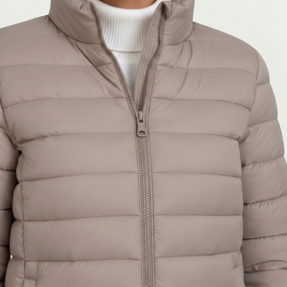 Women's quilted jacket featuring a slim fit design, lightweight construction, and casual style in a neutral tone, perfect for versatile layering. 1