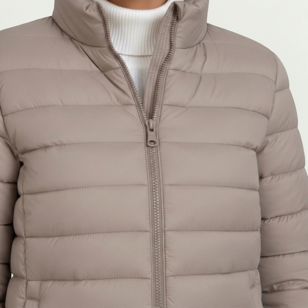 Women's quilted jacket featuring a slim fit design, lightweight construction, and casual style in a neutral tone, perfect for versatile layering. 1