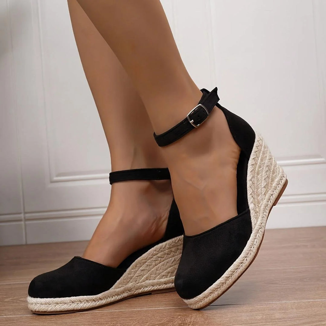 Women's sandals featuring an adjustable ankle strap and a stylish wedge heel, designed for comfort and casual summer wear. 0