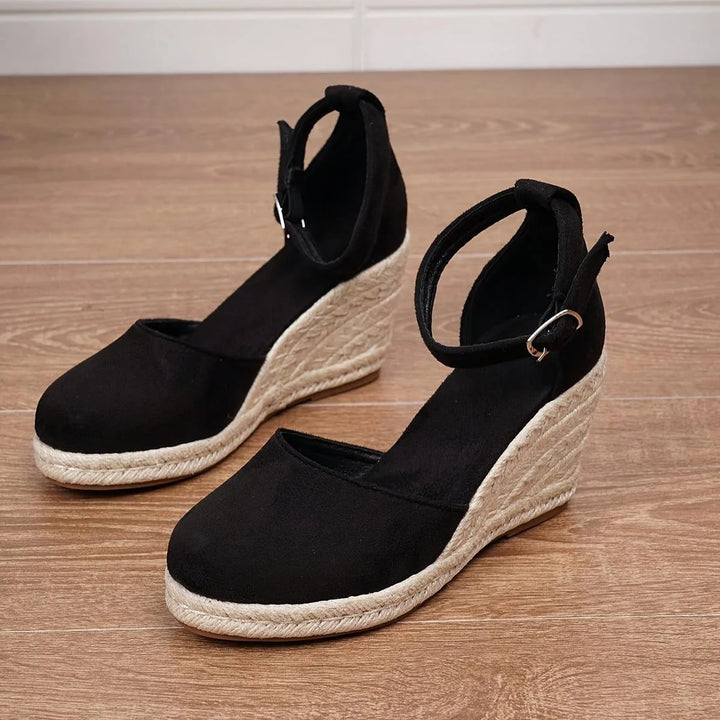 Women's sandals featuring an adjustable ankle strap and a stylish wedge heel, designed for comfort and casual summer wear. 1