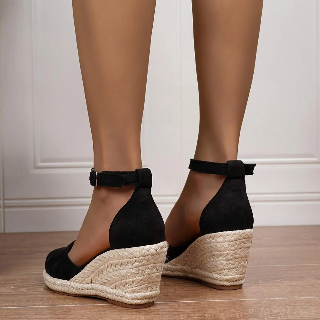 Women's sandals featuring an adjustable ankle strap and a stylish wedge heel, designed for comfort and casual summer wear. 2