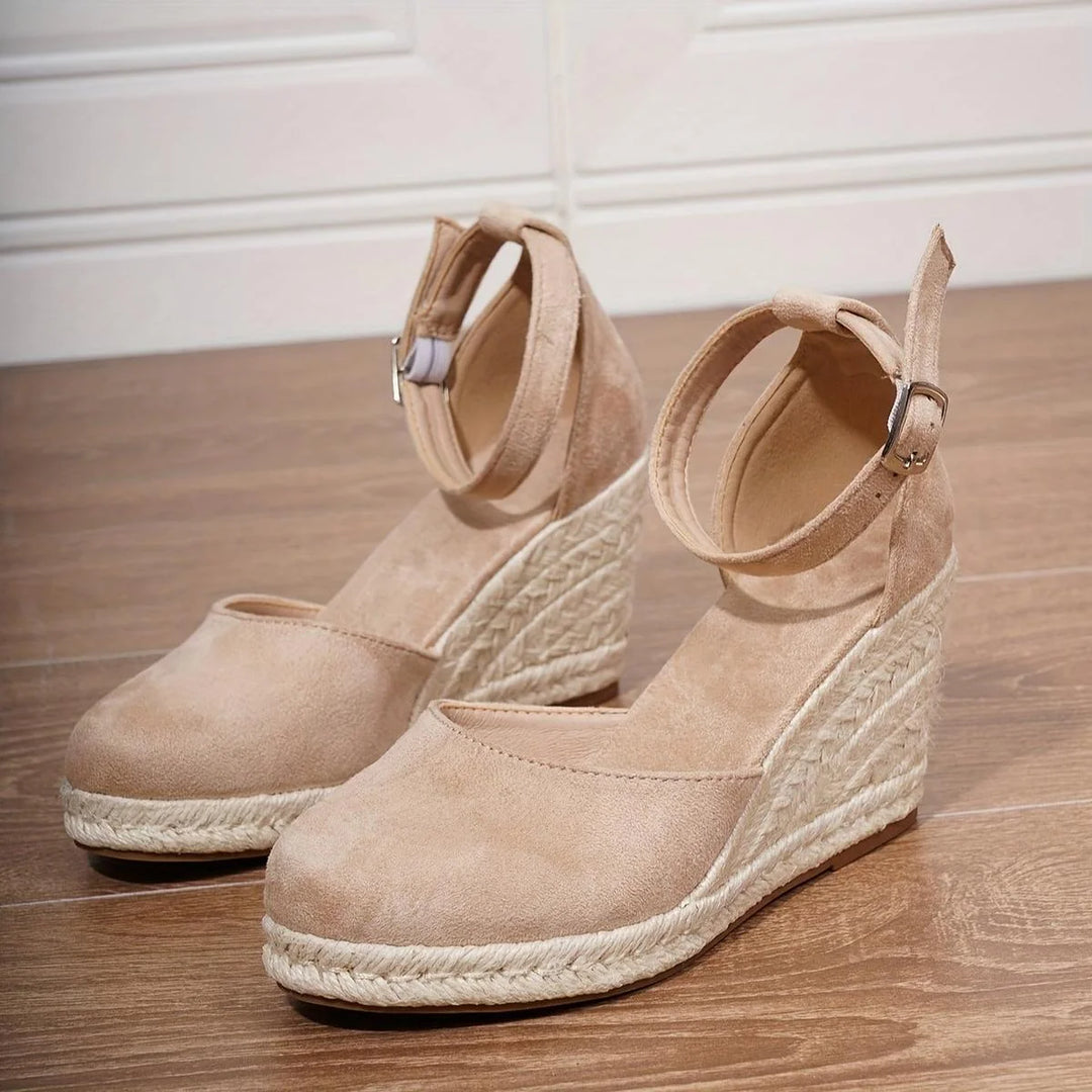 Women's sandals featuring an adjustable ankle strap and a stylish wedge heel, designed for comfort and casual summer wear. 4