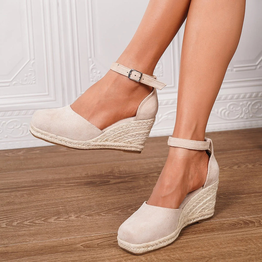 Women's sandals featuring an adjustable ankle strap and a stylish wedge heel, designed for comfort and casual summer wear. 6