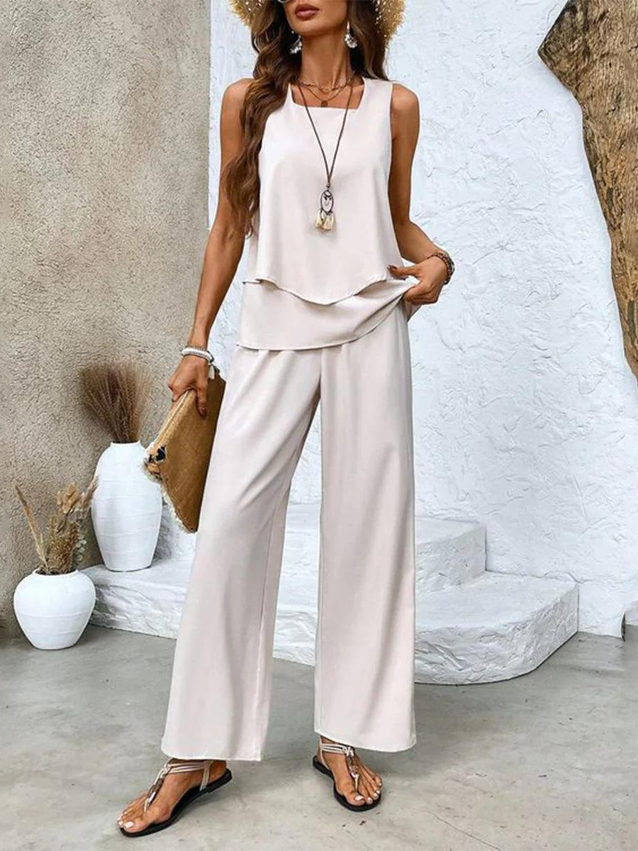 Women's summer set featuring a stylish layered top and wide-leg pants, perfect for casual outings. Lightweight and breathable fabric ideal for warm weather. 1