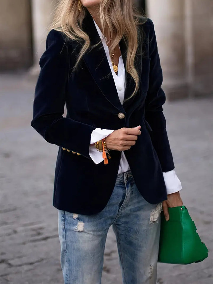 Women's black velvet blazer featuring a tailored design, ideal for versatile styling and elegant occasions. 0
