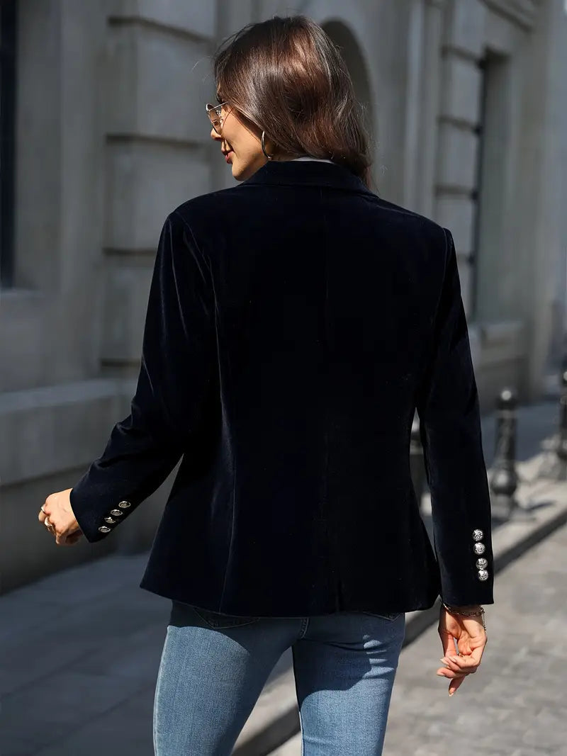 Women's black velvet blazer featuring a tailored design, ideal for versatile styling and elegant occasions. 1