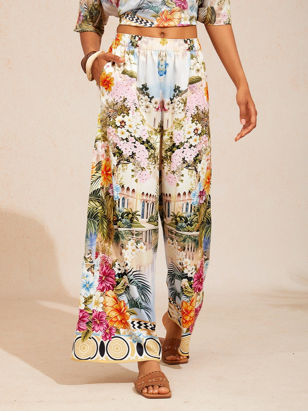 Women's wide-leg pants featuring an elastic waist and convenient pockets, designed with a beautiful floral satin pattern in glacier blue. 13