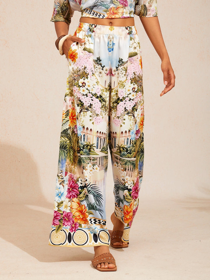 Women's wide-leg pants featuring an elastic waist and convenient pockets, designed with a beautiful floral satin pattern in glacier blue. 13