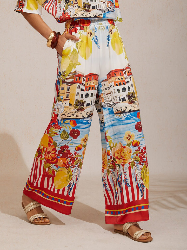 Women's wide-leg pants featuring an elastic waist and convenient pockets, designed with a beautiful floral satin pattern in glacier blue. 14