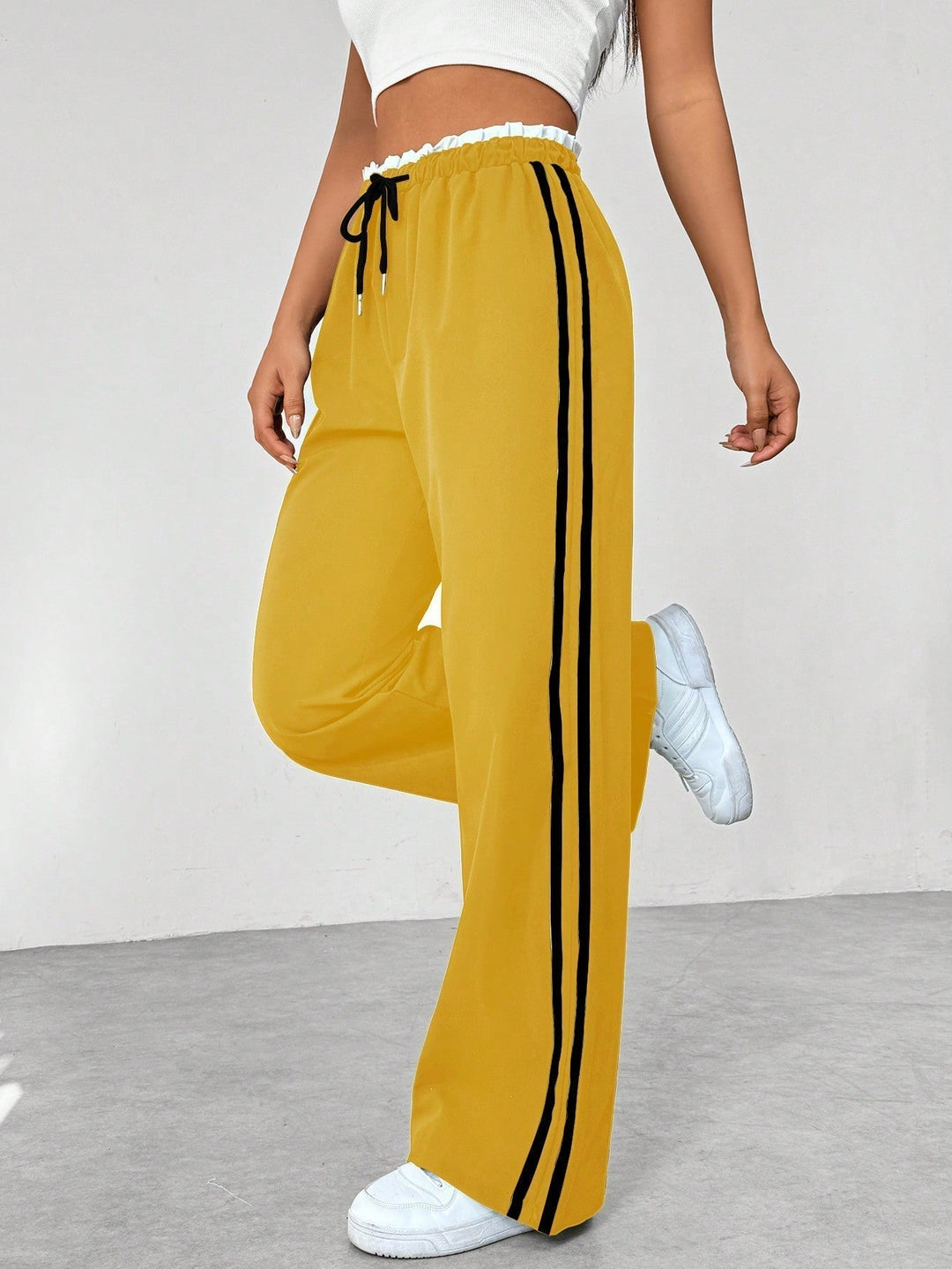 Women's wide leg trousers featuring an adjustable drawstring waist, sporty side stripes, and a lightweight design for a casual and comfortable look. 5