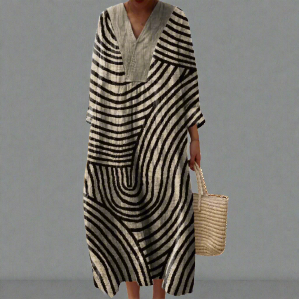 Womens dress featuring a fluid silhouette and geometric pattern, perfect for versatile day to night wear. 0