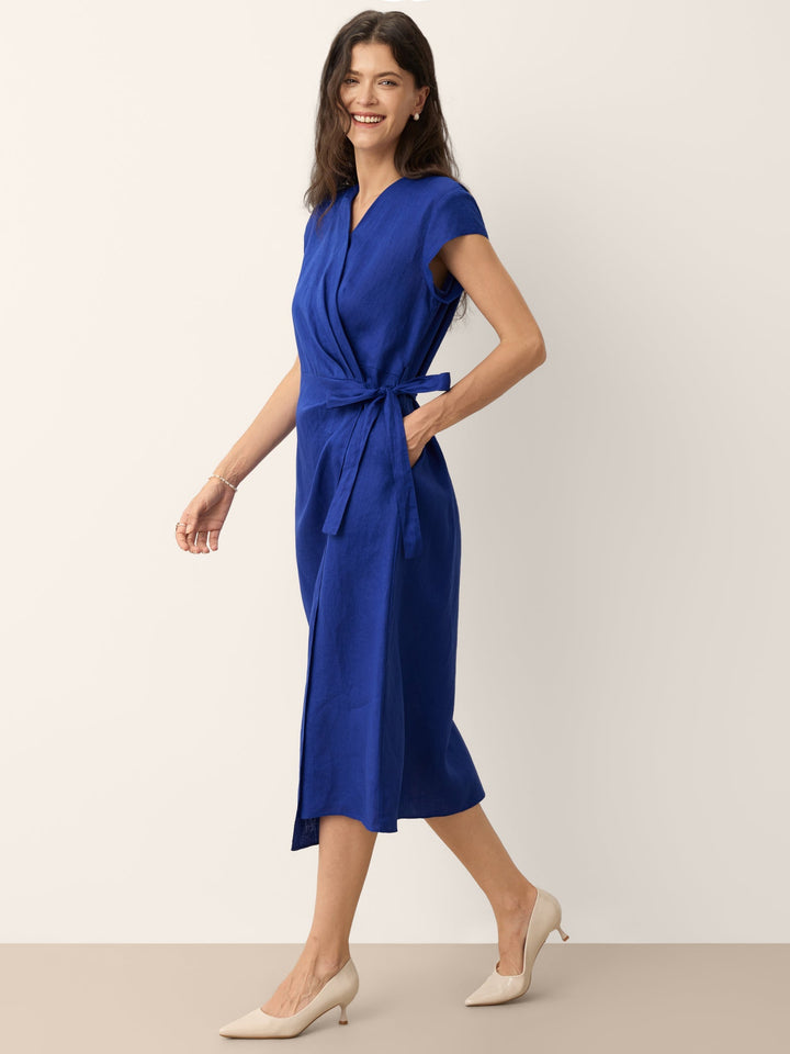 Womens linen midi wedding guest dress in cobalt blue featuring a wrap-tie waist and stylish cap sleeves. 3