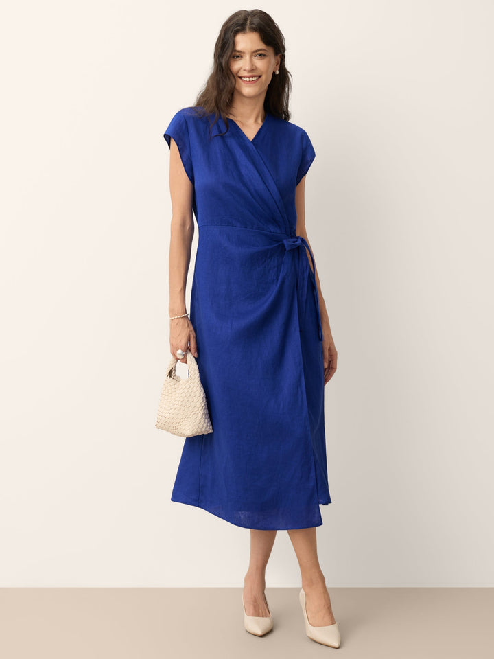Womens linen midi wedding guest dress in cobalt blue featuring a wrap-tie waist and stylish cap sleeves. 4