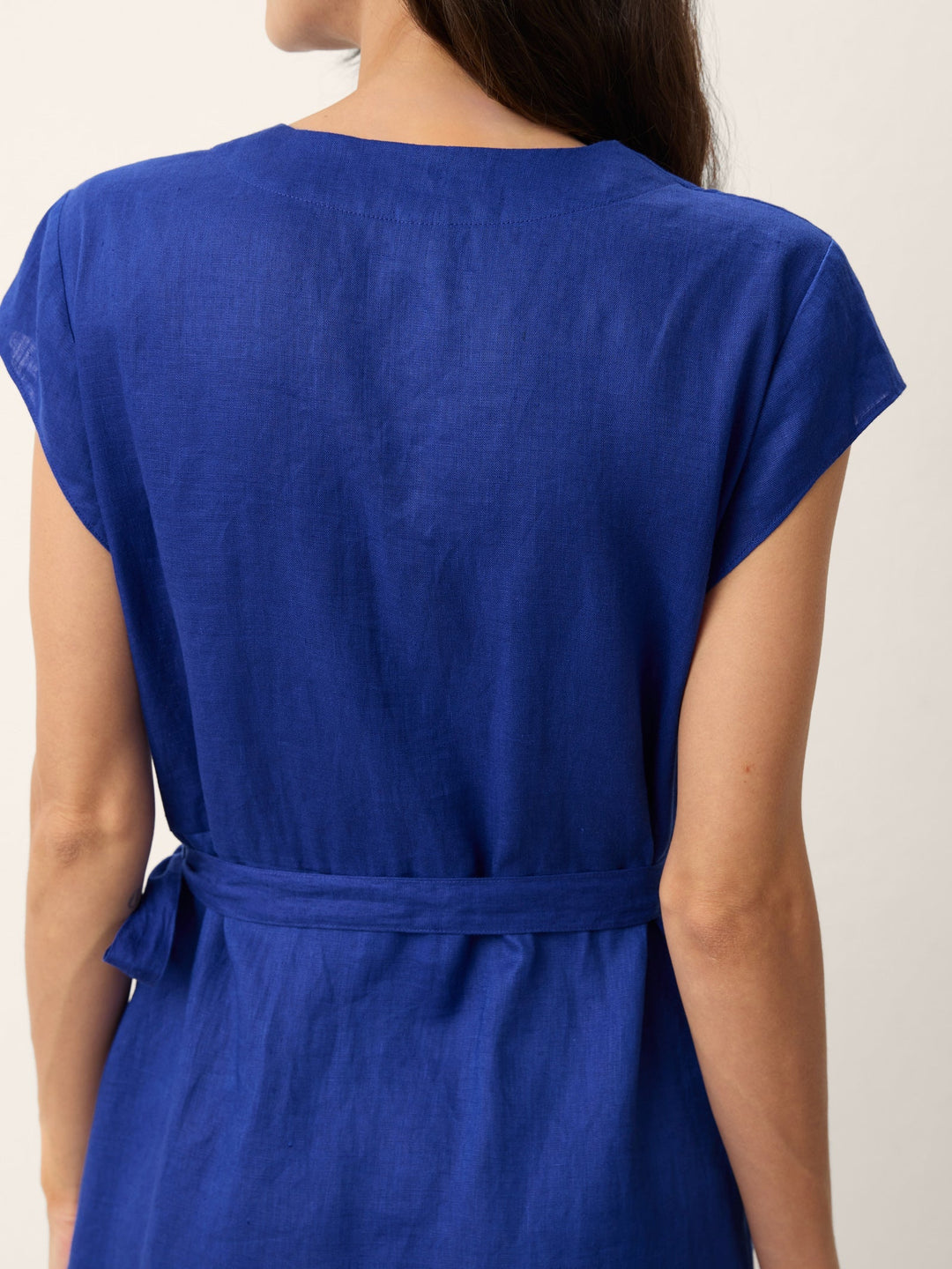 Womens linen midi wedding guest dress in cobalt blue featuring a wrap-tie waist and stylish cap sleeves. 7
