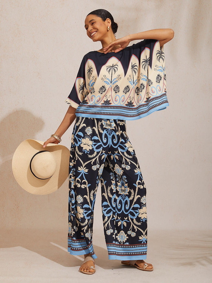 Womens top featuring an asymmetric hem and batwing sleeves in an abstract floral satin design, perfect for stylish and comfortable everyday wear. 10
