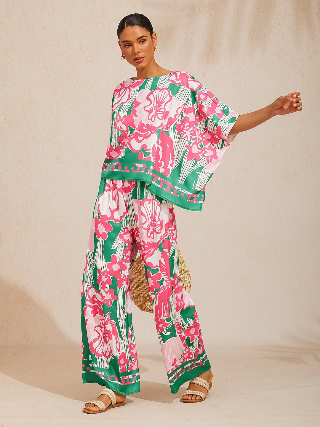 Womens top featuring an asymmetric hem and batwing sleeves in an abstract floral satin design, perfect for stylish and comfortable everyday wear. 12