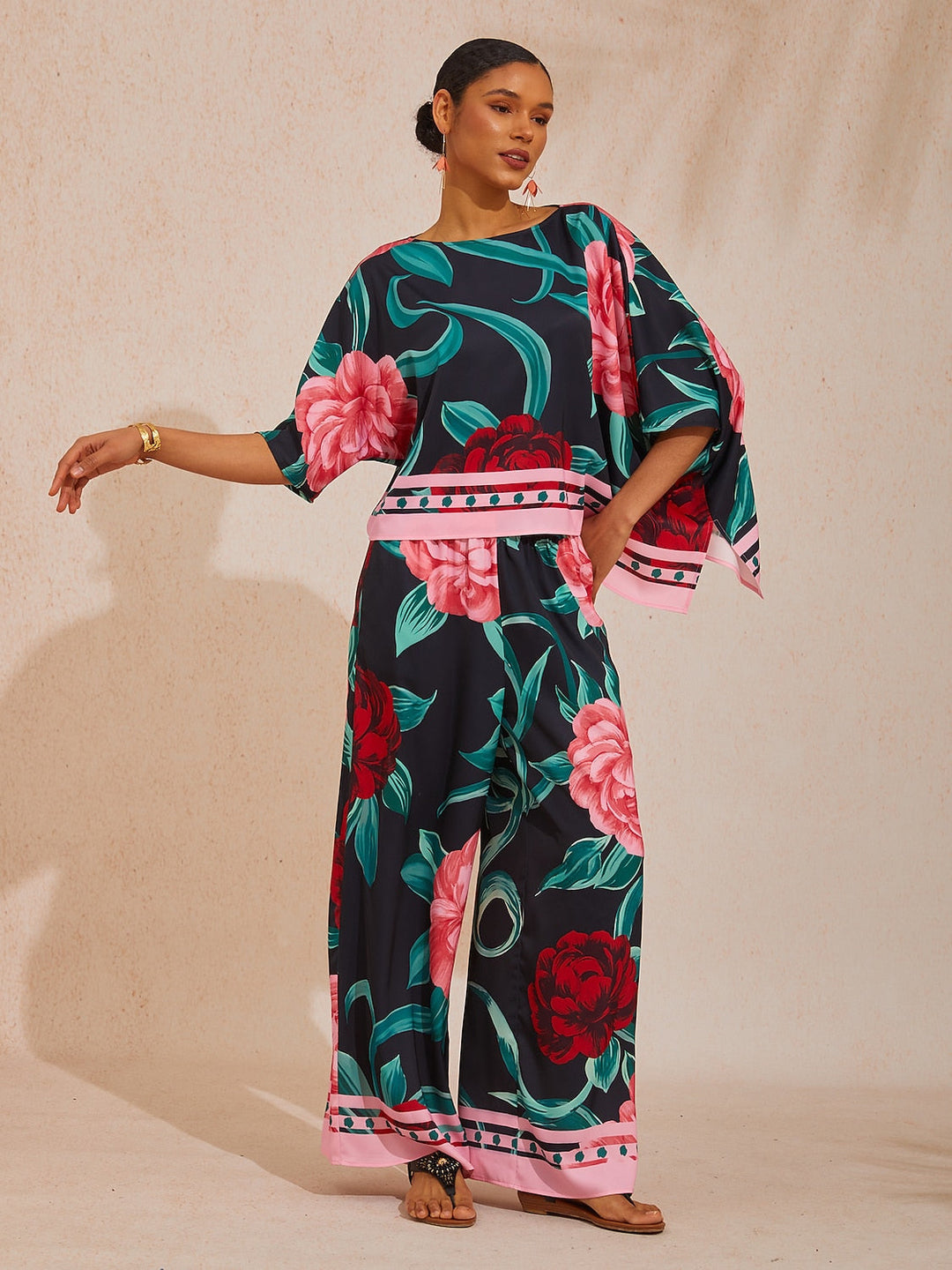 Womens top featuring an asymmetric hem and batwing sleeves in an abstract floral satin design, perfect for stylish and comfortable everyday wear. 17
