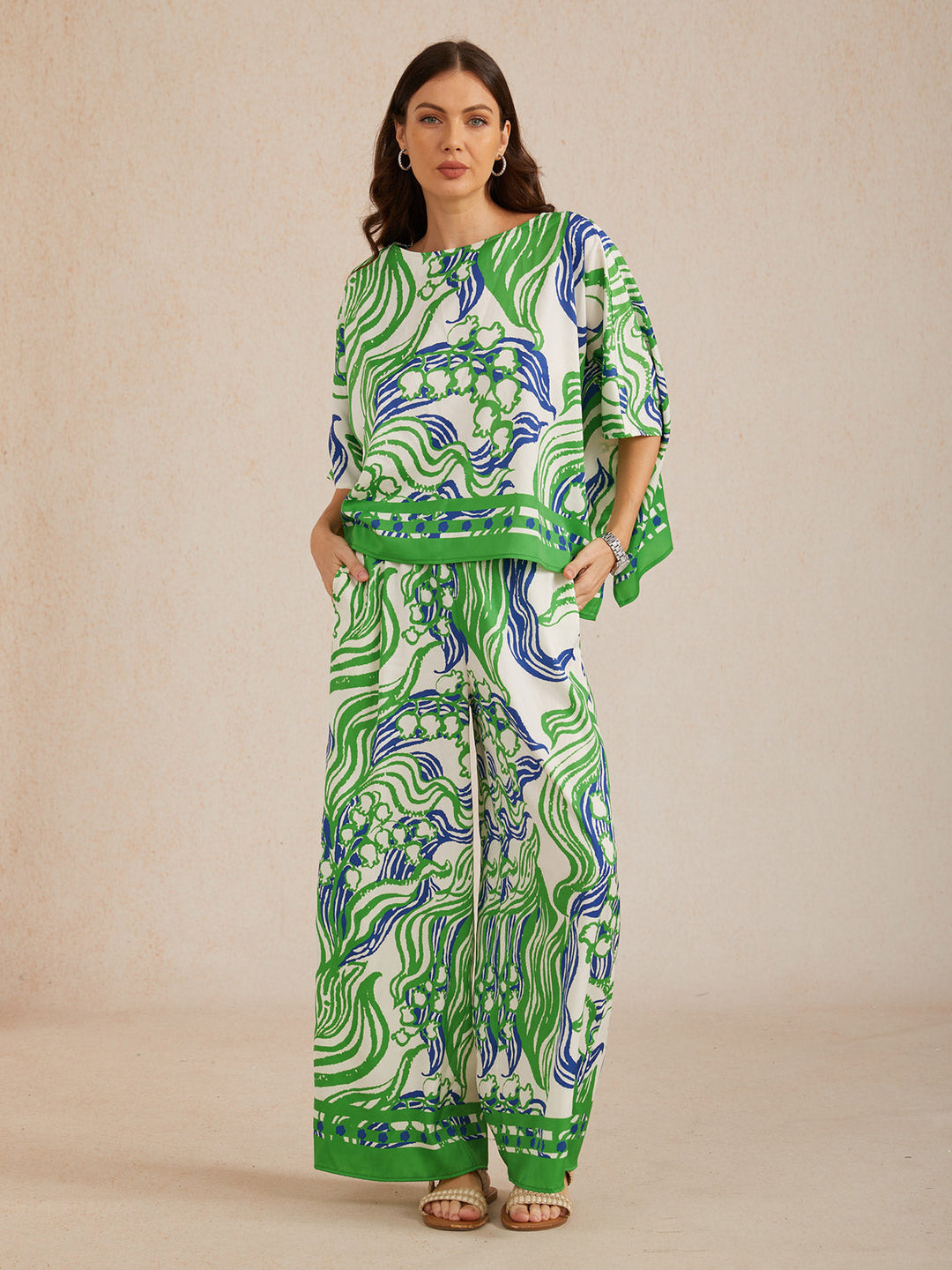 Womens top featuring an asymmetric hem and batwing sleeves in an abstract floral satin design, perfect for stylish and comfortable everyday wear. 4