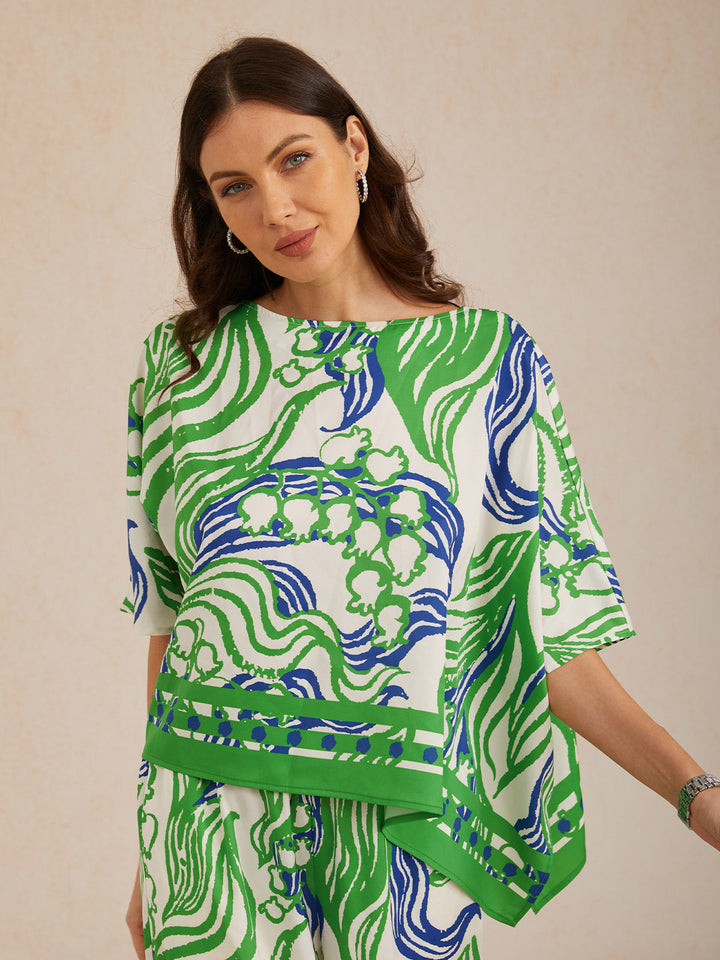 Womens top featuring an asymmetric hem and batwing sleeves in an abstract floral satin design, perfect for stylish and comfortable everyday wear. 5