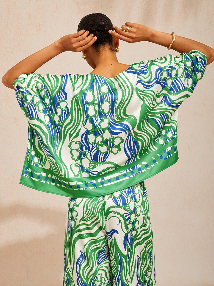Womens top featuring an asymmetric hem and batwing sleeves in an abstract floral satin design, perfect for stylish and comfortable everyday wear. 6