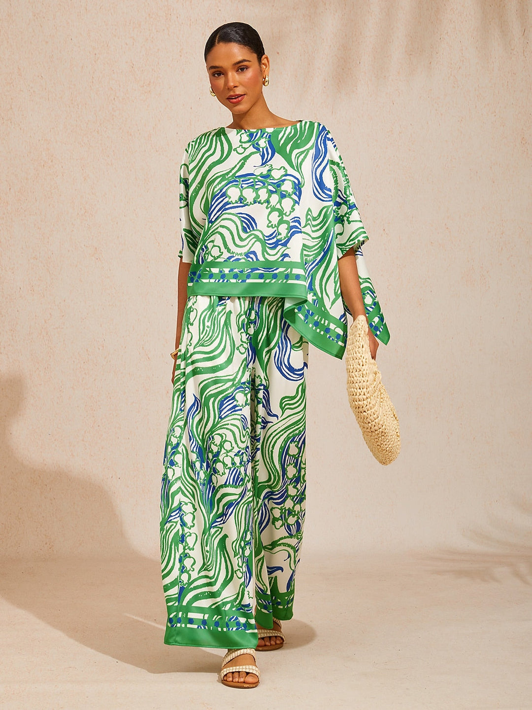 Womens top featuring an asymmetric hem and batwing sleeves in an abstract floral satin design, perfect for stylish and comfortable everyday wear. 7