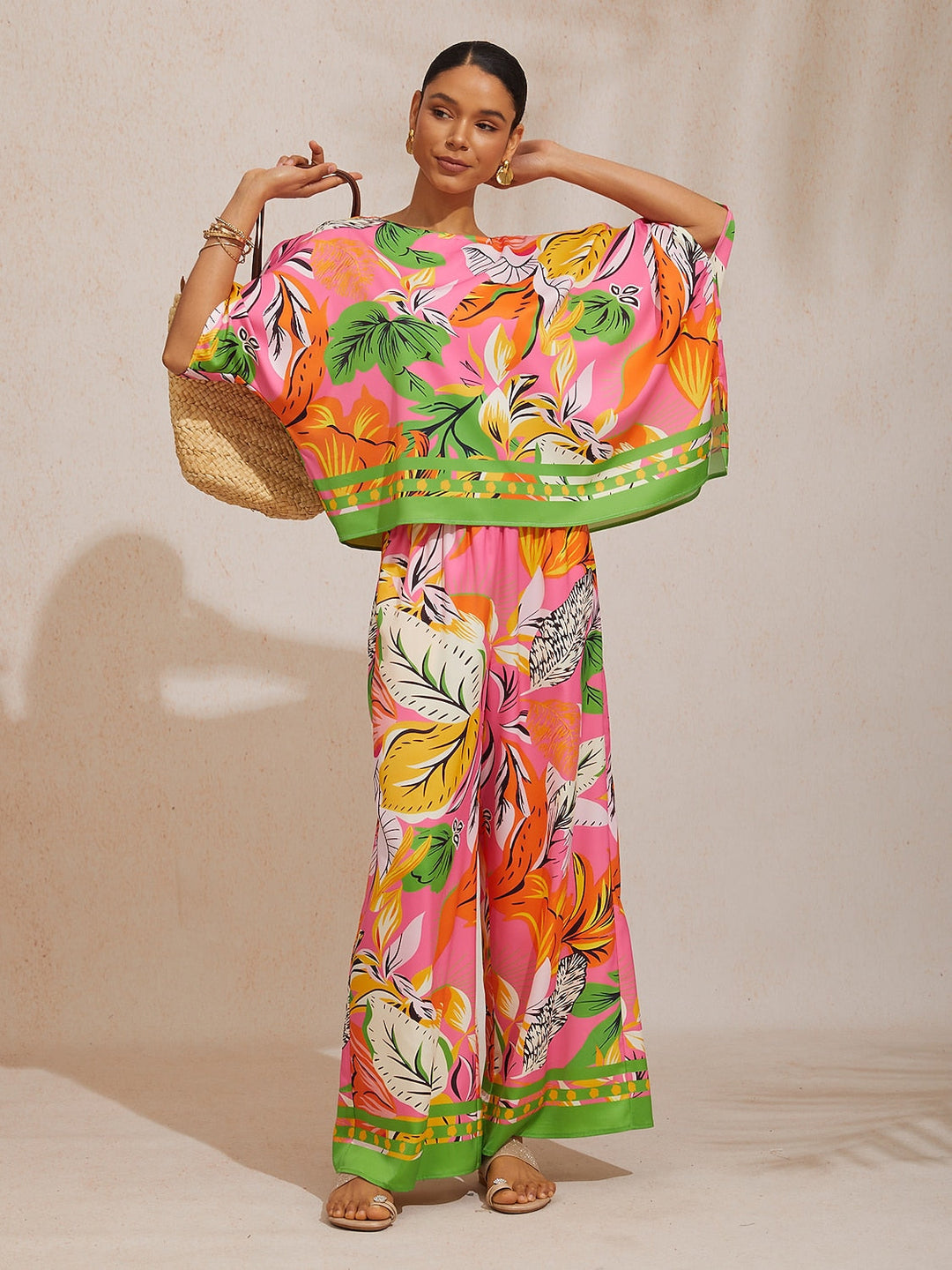 Womens top featuring an asymmetric hem and batwing sleeves in an abstract floral satin design, perfect for stylish and comfortable everyday wear. 8