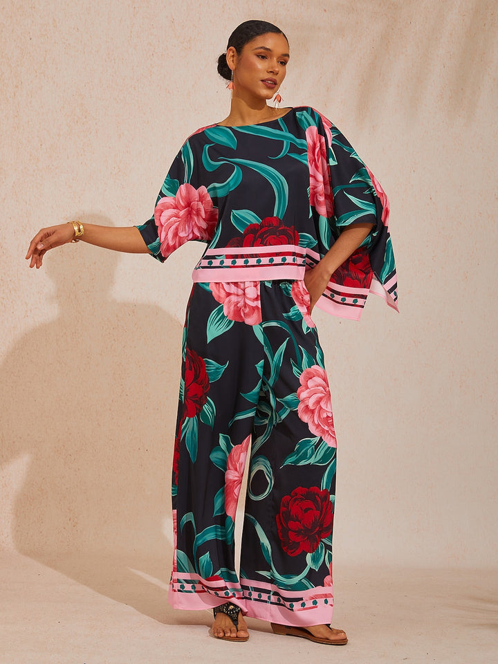 Womens silky satin floral blouse in glacier blue featuring an asymmetrical hem and dolman sleeves, perfect for stylish casual wear. 17