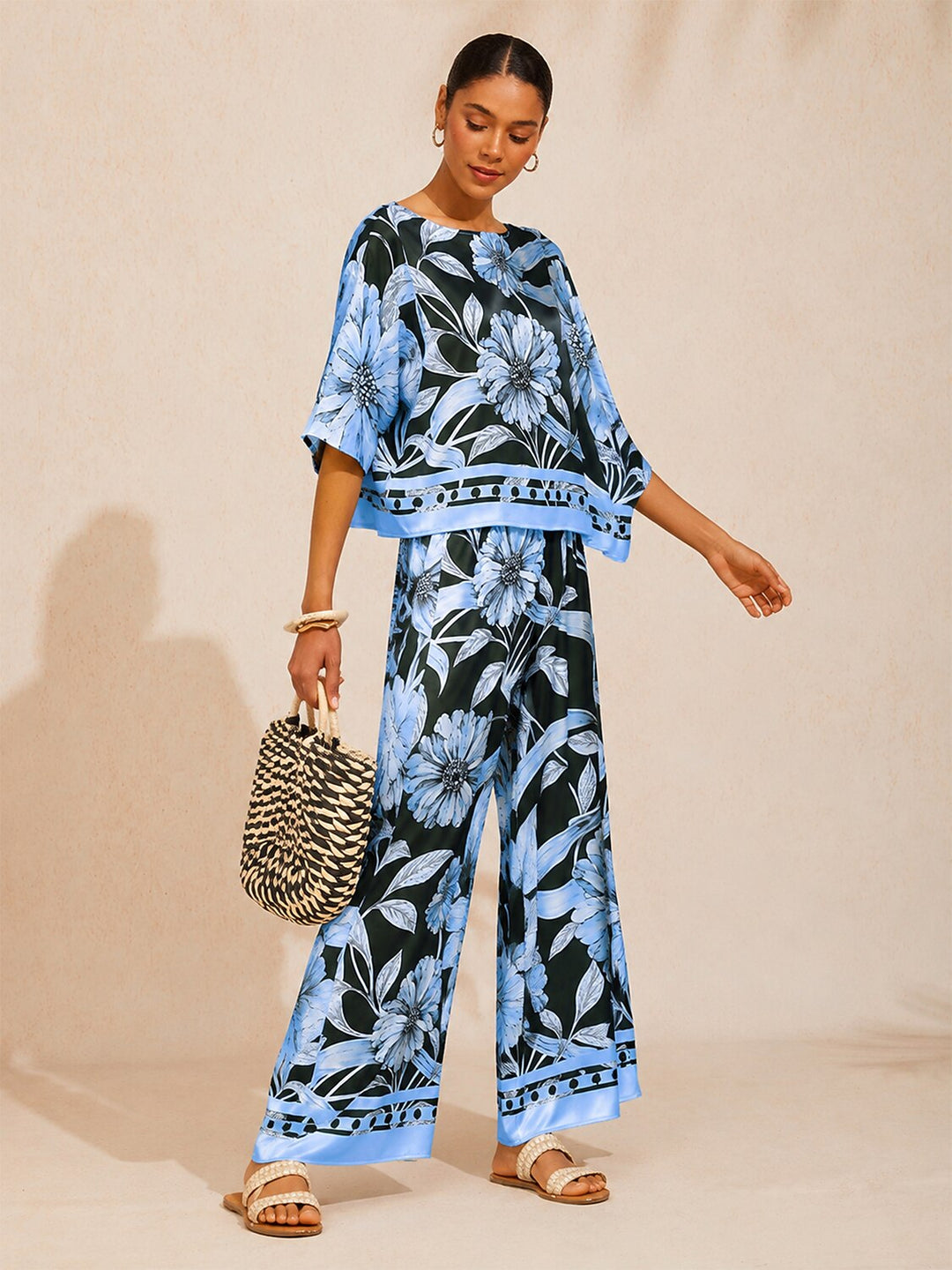 Womens silky satin floral blouse in glacier blue featuring an asymmetrical hem and dolman sleeves, perfect for stylish casual wear. 2