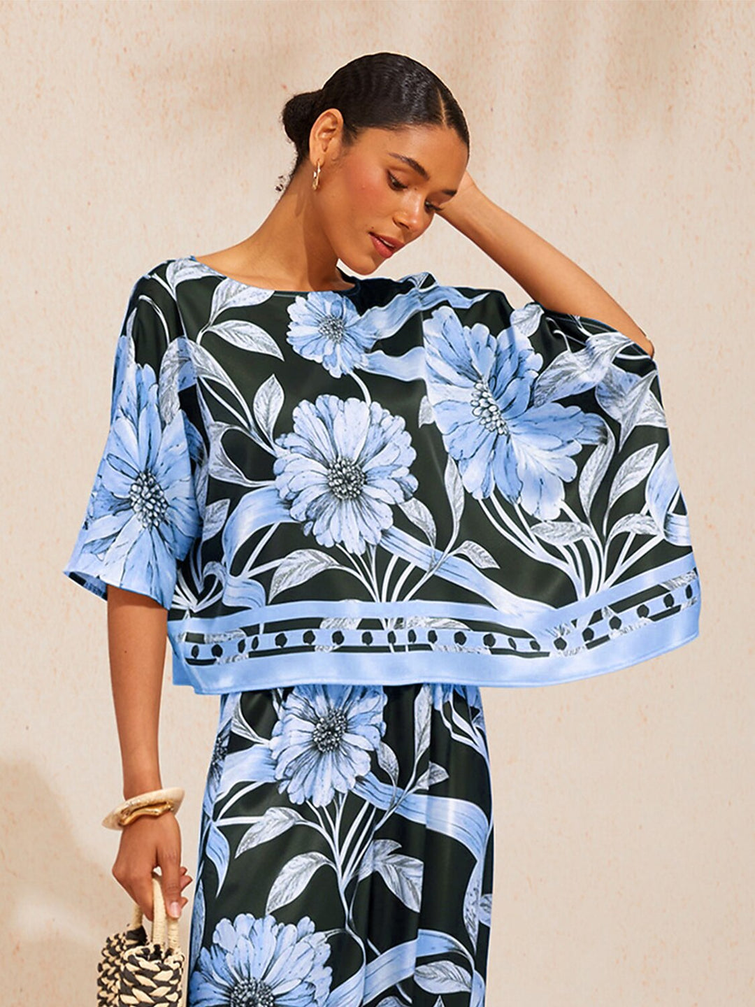 Womens silky satin floral blouse in glacier blue featuring an asymmetrical hem and dolman sleeves, perfect for stylish casual wear. 3